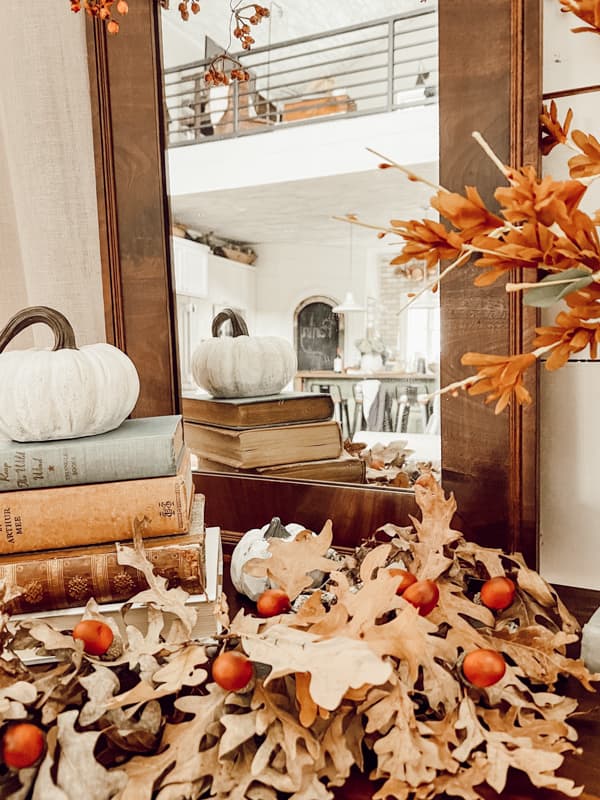 Fall Table Set-up with vintage books and old mirror and pumpkins for an autumn entry table.  