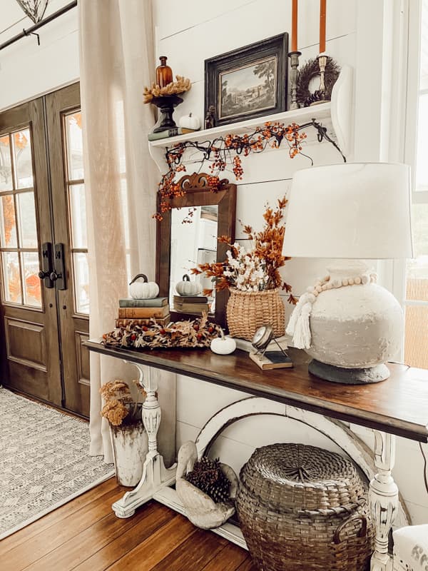 Farmhouse French Doors at entryway and table with fall vignette including DIY earthenware lamp, handcrafted thrift store finds and more.