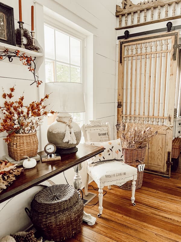 Fall Vignette with DIY lamp and pillow beside the antique barn door. Farmhouse industrial style.