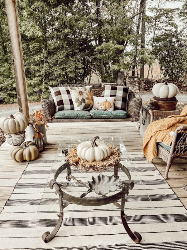Large Front Porch decorating ideas with neutral colors on porch swing and seating area.