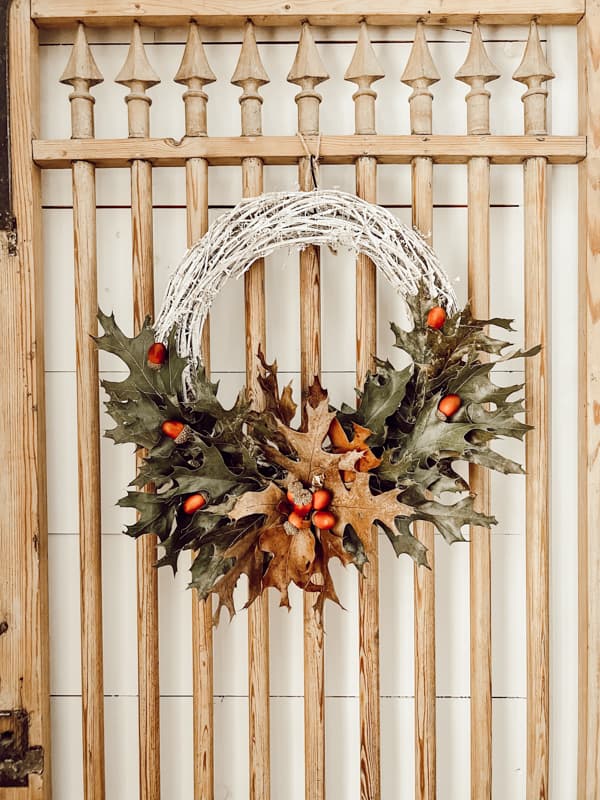 Wreath made from foraged oak leaves. Vintage door with grapevine and oak leaves.