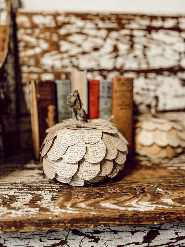 Old Book Craft to make Dollar Tree Craft Ideas - DIY Pumpkin on chippy old church pew.  