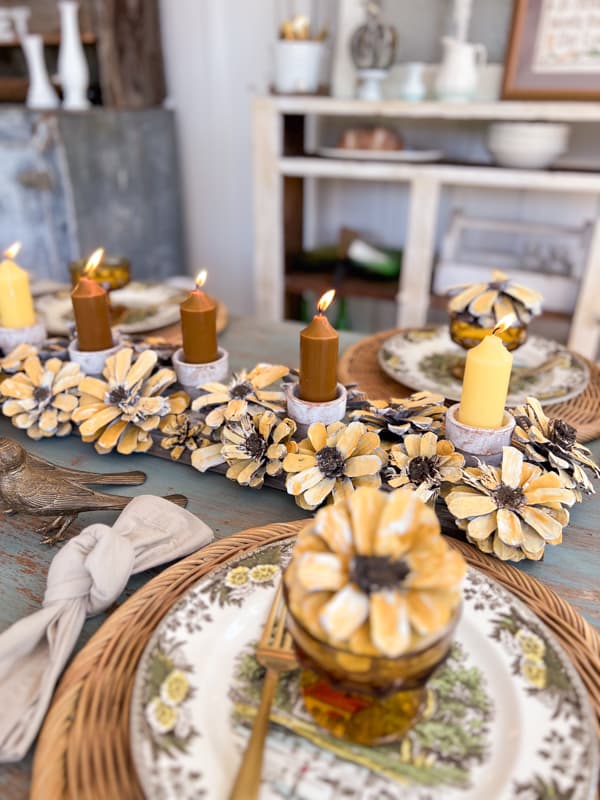 Pinecone Flower Centerpiece made with pinecones and reclaimed shiplap wooden board for rustic decor.