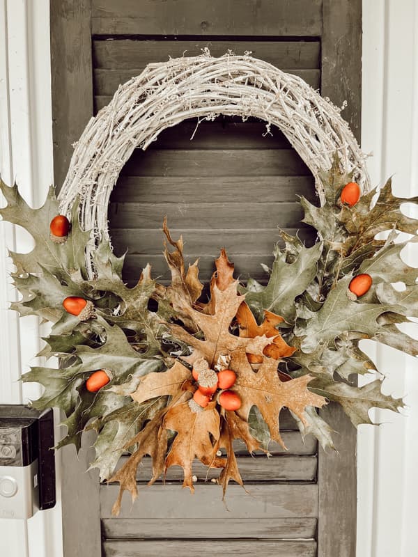 Oak Leaves wreath on front porch shutter for a rustic farmhouse decoration