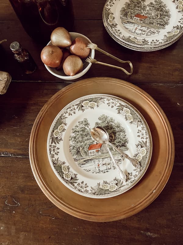 Thrifted Pottery Barn copper plate chargers. Vintage plate and spoons.