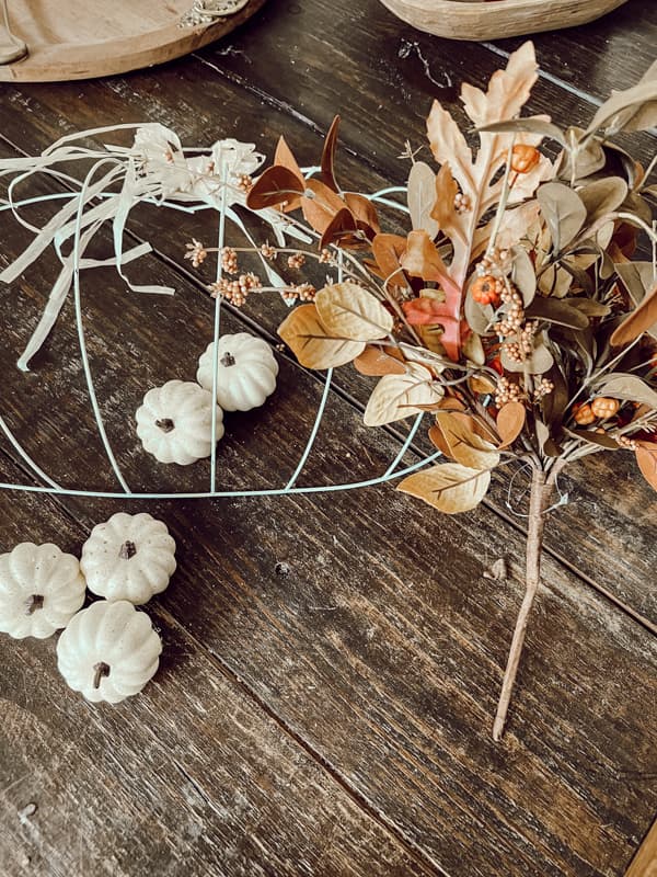 Budget-friendly wire pumpkin. Faux twigs with fall leaves.