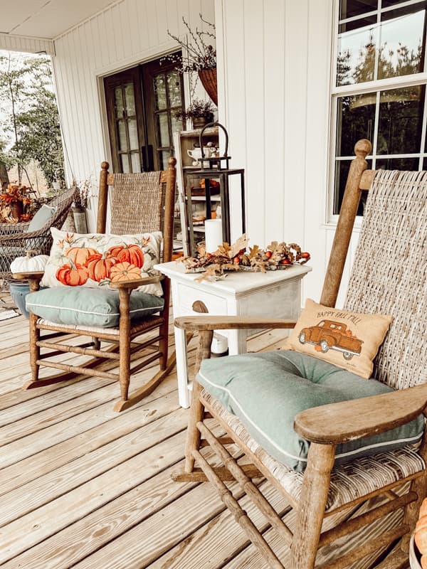 Seating ideas for fall farmhouse front porch ideas with rockers and pillows.
