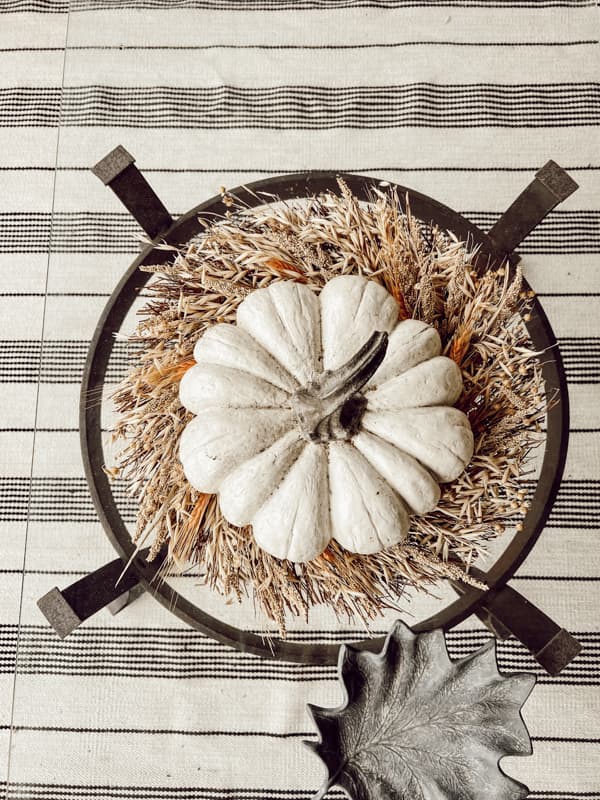 Pumpkin on the wheat wreath on the coffee table on front porch.  