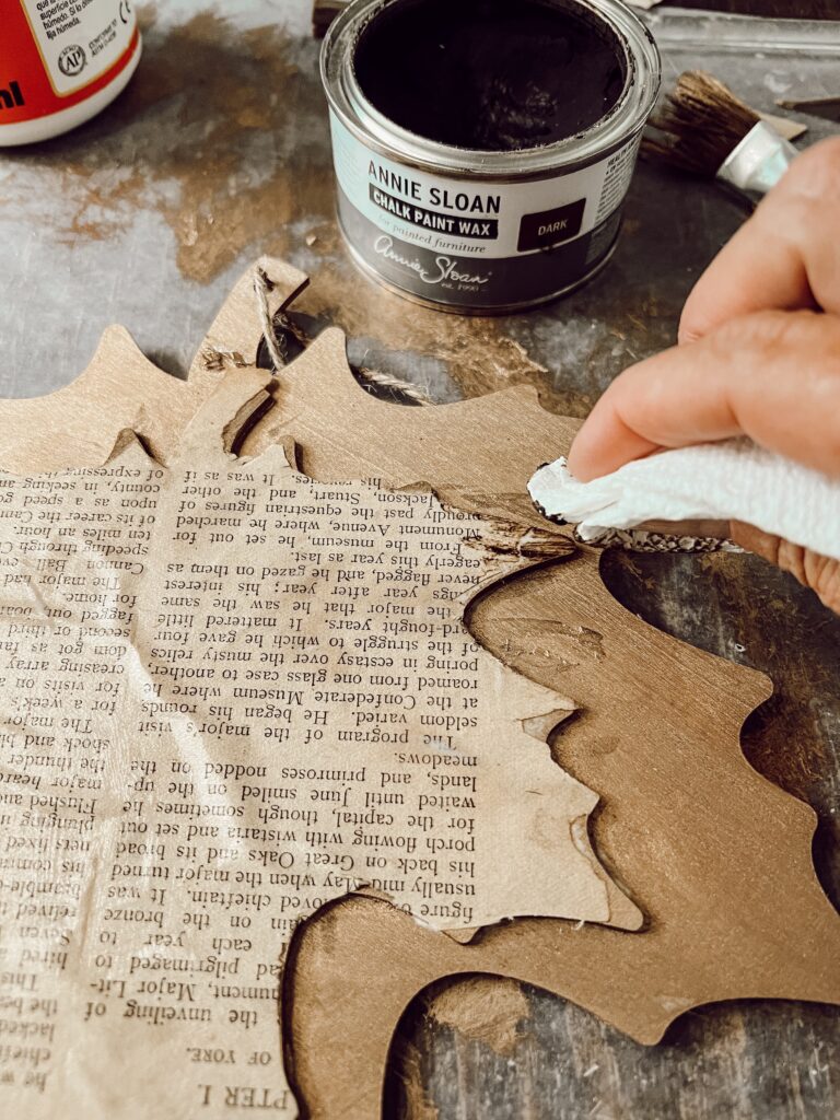 Add dark wax to age the old book page leaf craft.  Farmhouse Style Craft Project with Dollar Tree Supplies.