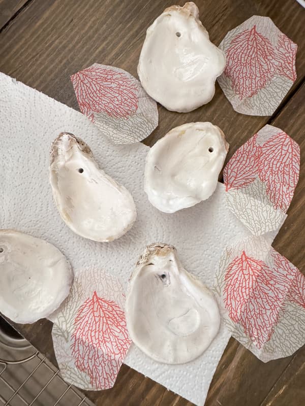 Cut the top decorative layer the size of the oyster shell to decoupage them for a beach cottage decoration.
