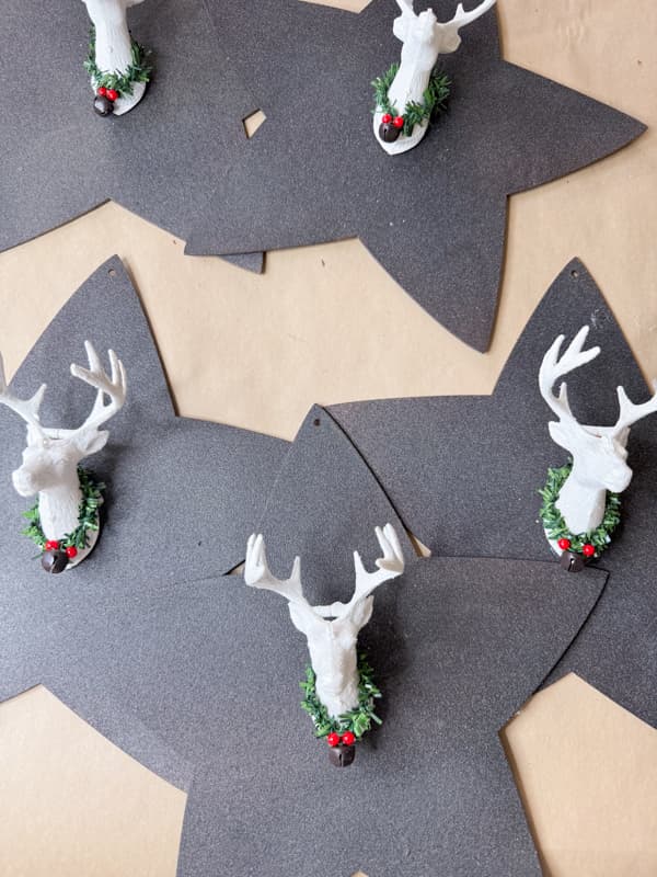 Add deer head Dollar Tree ornaments to the star wood cutouts for unique holiday decor.