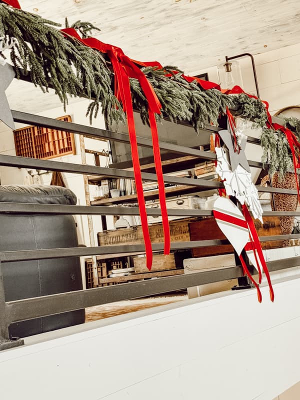 Garland on banister with Dollar Tree Christmas Items mad into large Christmas ornaments