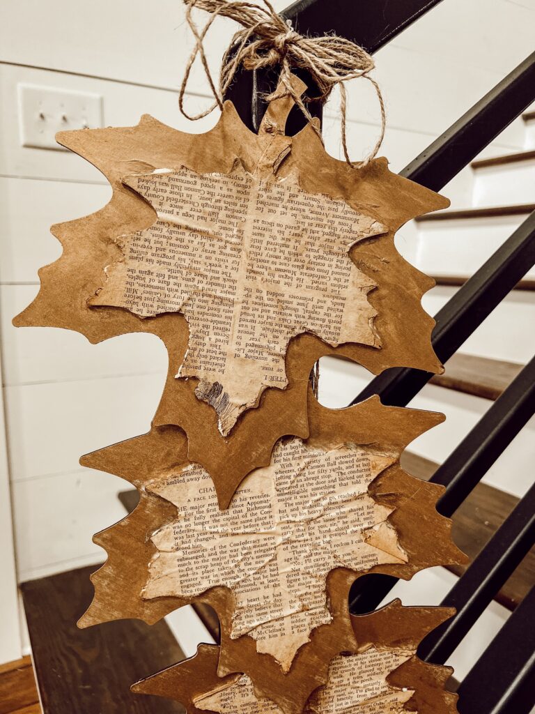 Hang DIY Fall Leaf Project on Farmhouse Banister to decorate with a rustic fall style.