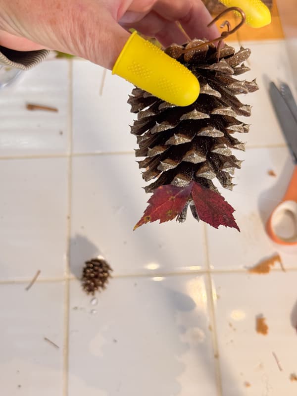 Add leaves for the gobble on the pinecone turkey craft 