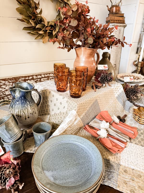 Thanksgiving Buffet Table Set up with earthenware dishes and amber glasses for beverages.