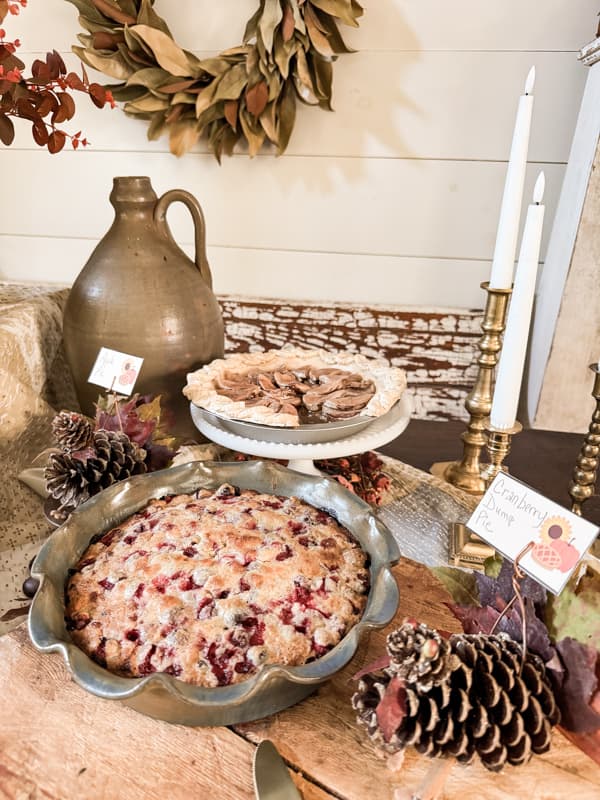 Table set up for a Thanksgiving Pie 
Party with rustic farmhouse style decor, earthenware pottery and DIY tableware.