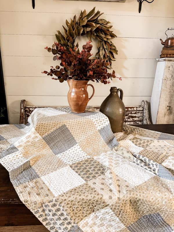 Thanksgiving Buffet Table Set up with quilted tablecloth and earthenware pottery 