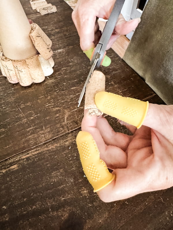 Cut corners of wine corks to allow them to fit on cone.