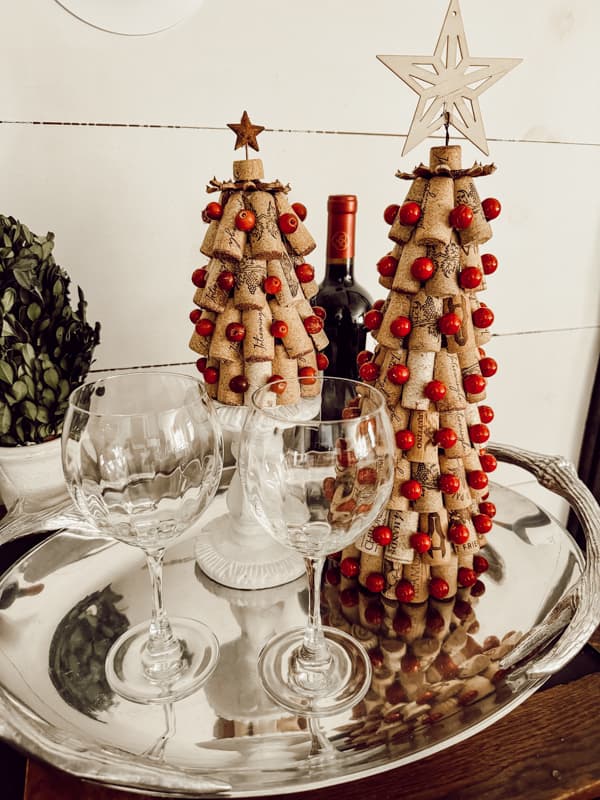 two trees on a silver tray with wine glasses.