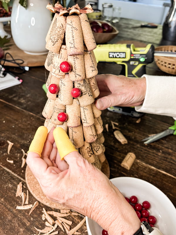 Add faux berries to the Wine Cork Christmas Tree Craft