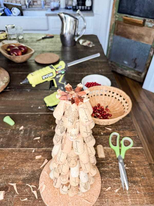 Add pinecone scales to top of the DIY Recycled Wine Cork Craft