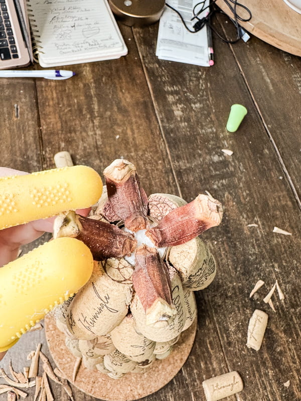 Add pinecone scales to top of the DIY Recycled Wine Cork Craft. 