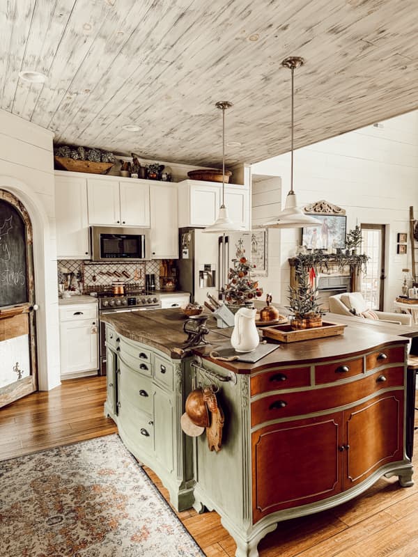 DIY Kitchen Island decorate with vintage style for Christmas.  White enamelware vintage light fixtures and white cabinets.