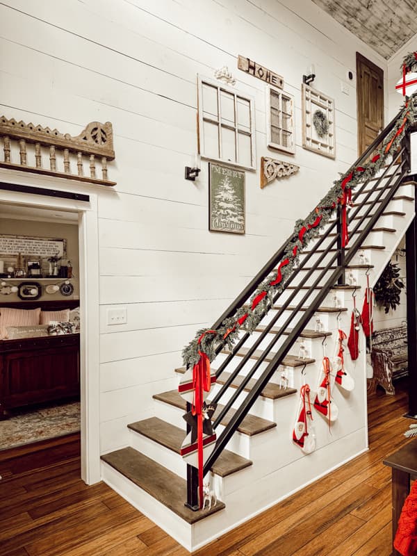 Industrial Staircase with greenery and DIY projects in a curated home for Christmas.