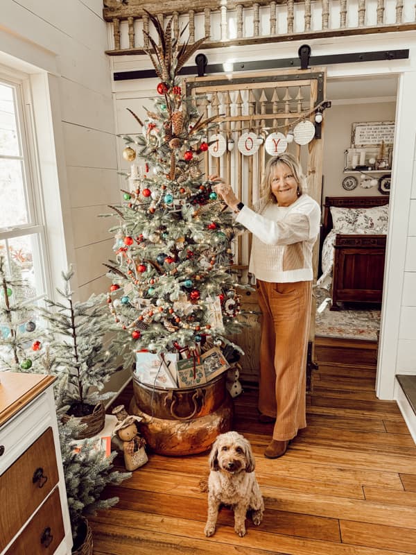 Vintage Christmas Glass Ornaments Shiny Brites fill the tree inside a vintage copper cauldron.  Rudy is helping. 