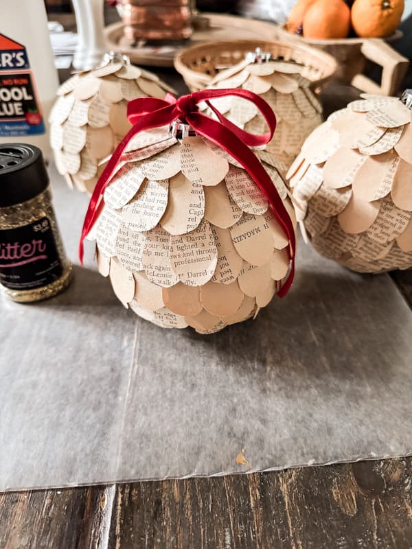 Upcycled old book big Christmas ornaments for farmhouse decorating.