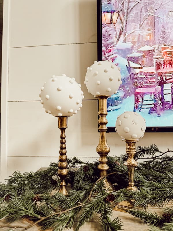 Place milk glass ornaments on candlestick on mantel for Christmas