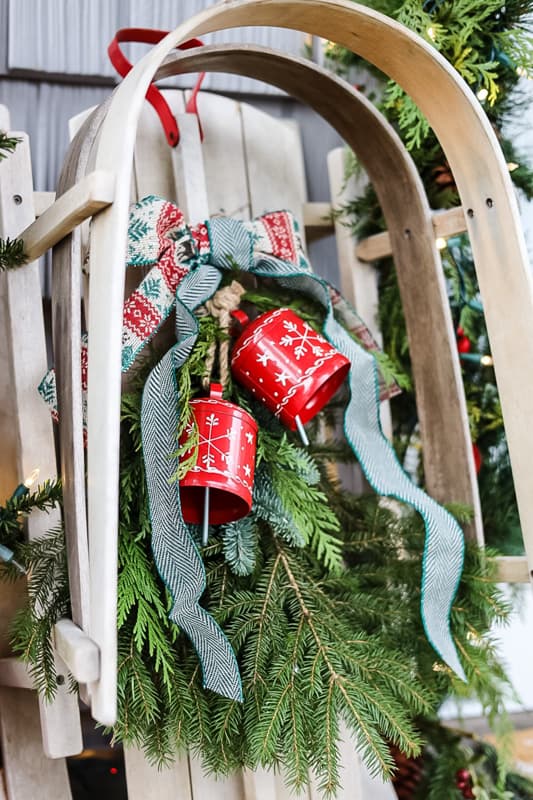 New England Style Christmas Decorated Porch with sleigh and bells.