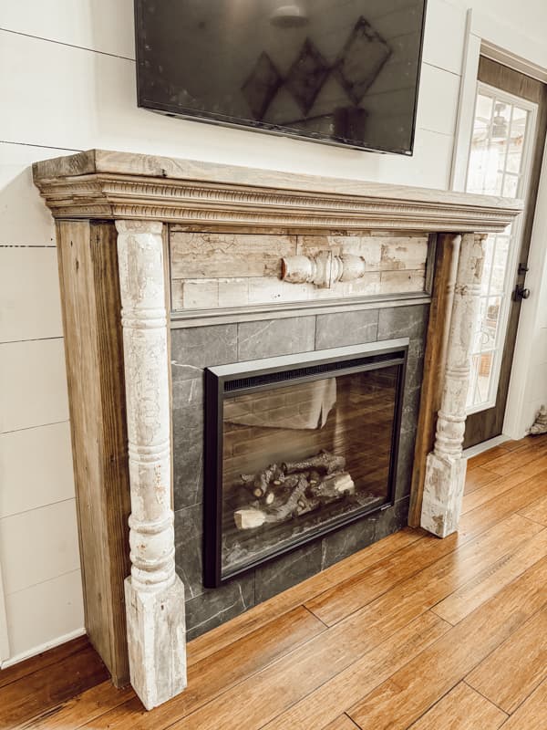 Architectural Salvage old porch posts repurposed into a shabby chic faux fireplace mantel.  