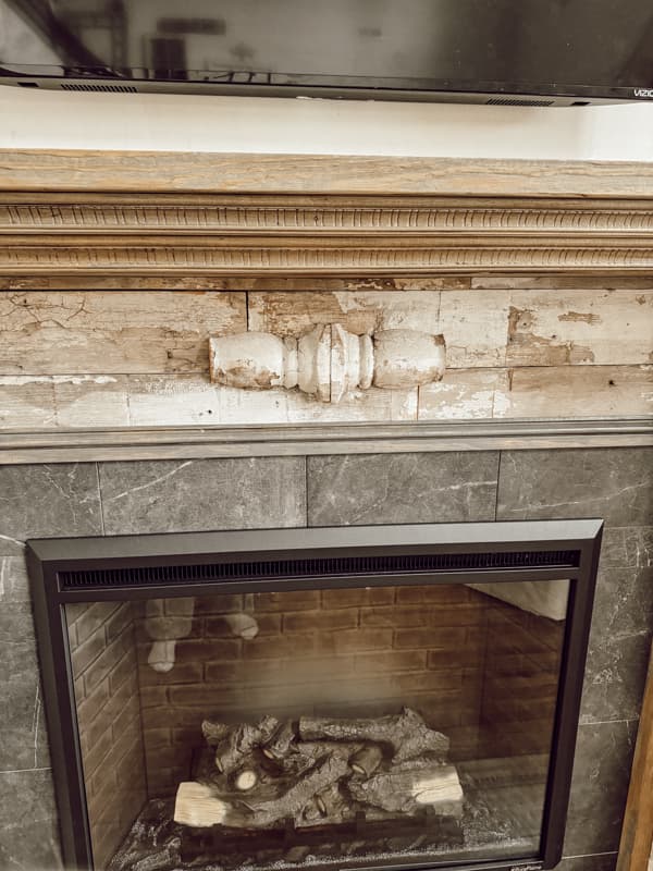 Architectural salvage materials to make a Shabby Chic DIY Mantel that look like an authentic antique with electric fireplace.