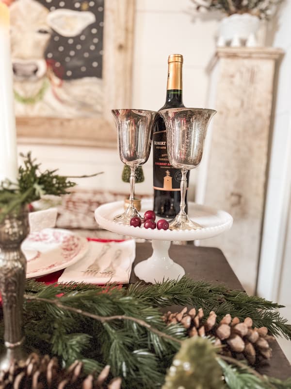 Cake stand hold silver goblets and wine bottler for Christmas Farmhouse Decor Ideas.  