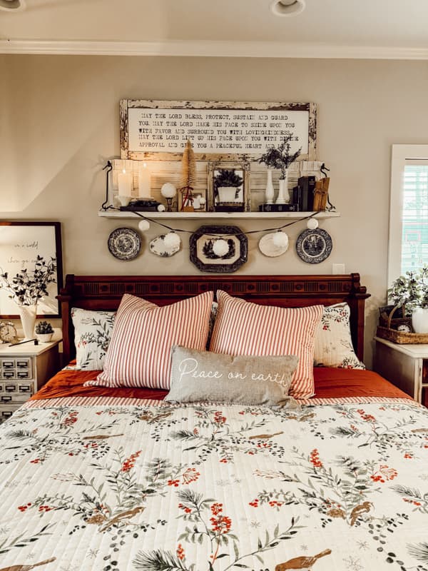 Christmas bedding with holly and birds.  red and white ticking pillows.