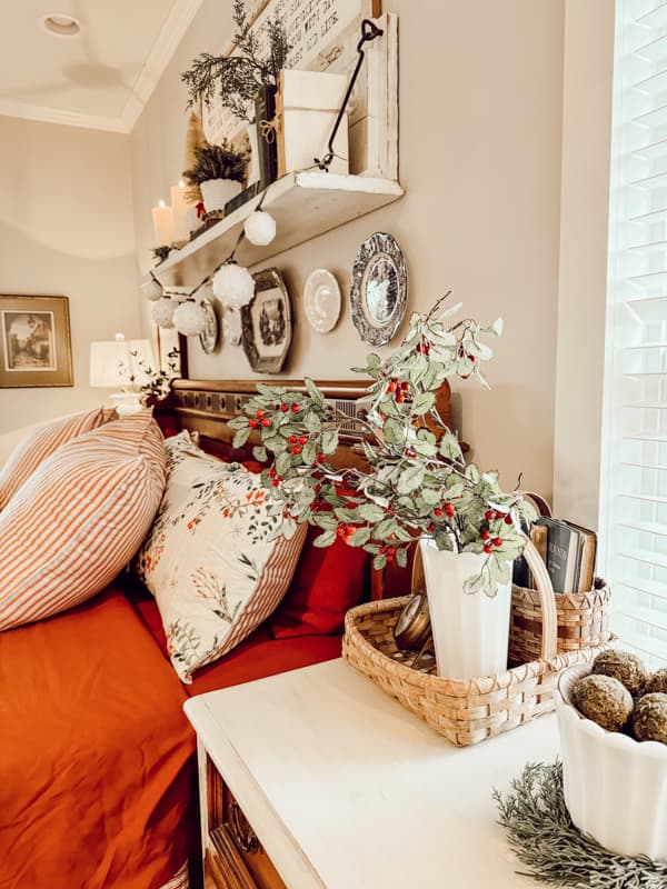 Bedside table with vase of Christmas evergreens.Christmas Farmhouse Decor Ideas