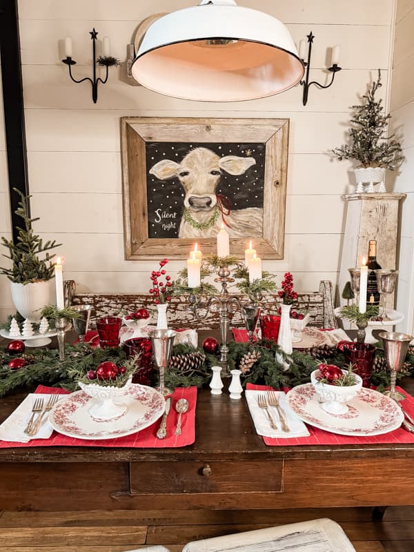 Decorating with Vintage Silver Candelabra on a holiday red and white table with milk glass and transferware. 