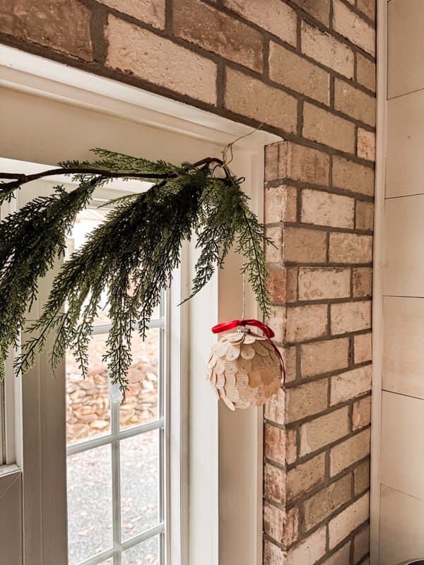 Old book page DIY oversized Christmas Ornaments for a unique budget-friendly holiday Dollar Tree Craft upgrade. 