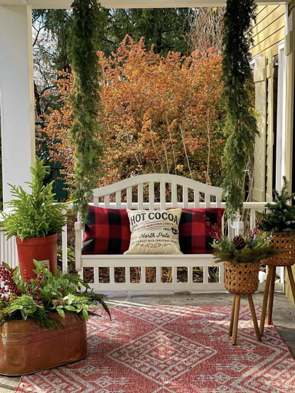 Farmhouse swing on front porch.