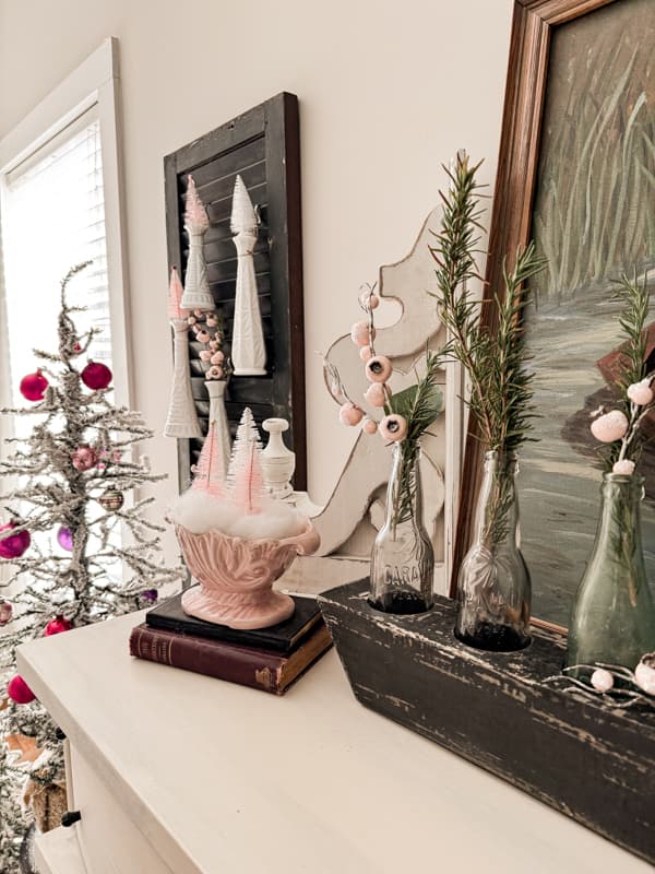 Old shutter with vintage white milk glass bud vases and pink bottle brush trees for Pink Christmas Decorating 