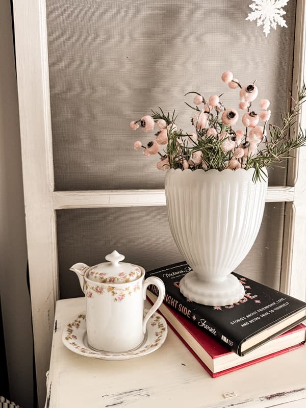 Vintage milk glass vase filled with fresh rosemary and pink berries for Pink Christmas Decorating