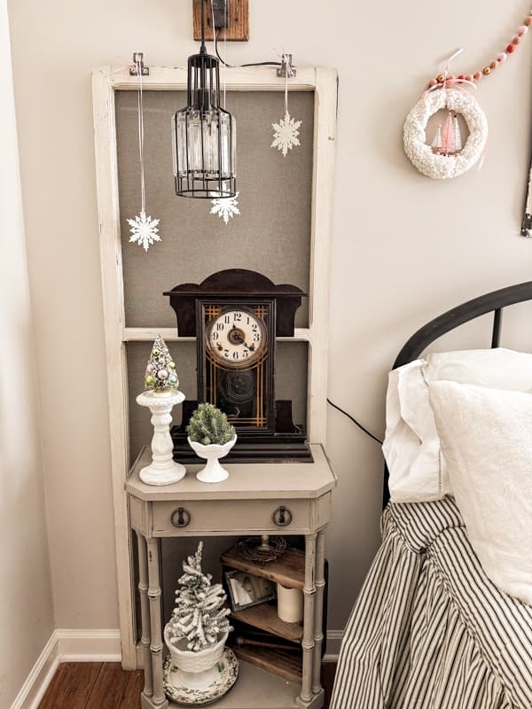 Dollar tree snowflake ornaments hang from pink ribbons on the vintage screens.