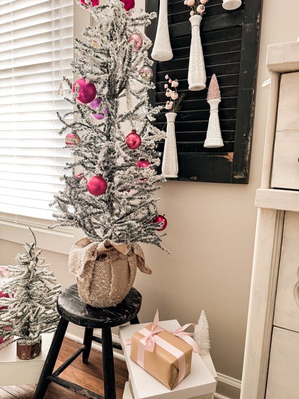 Pink Christmas Decorations with vintage shiny brite ornaments vintage milk glass vases filled with pink bottle brush trees.  