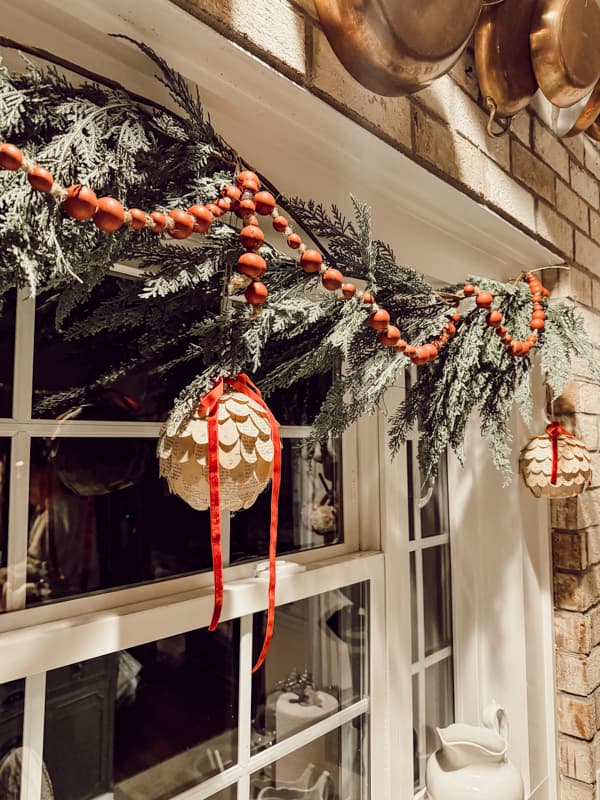 DIY Old Book Page Ornaments made with oversized Dollar Tree Ornaments for a Cottage core Christmas Style.