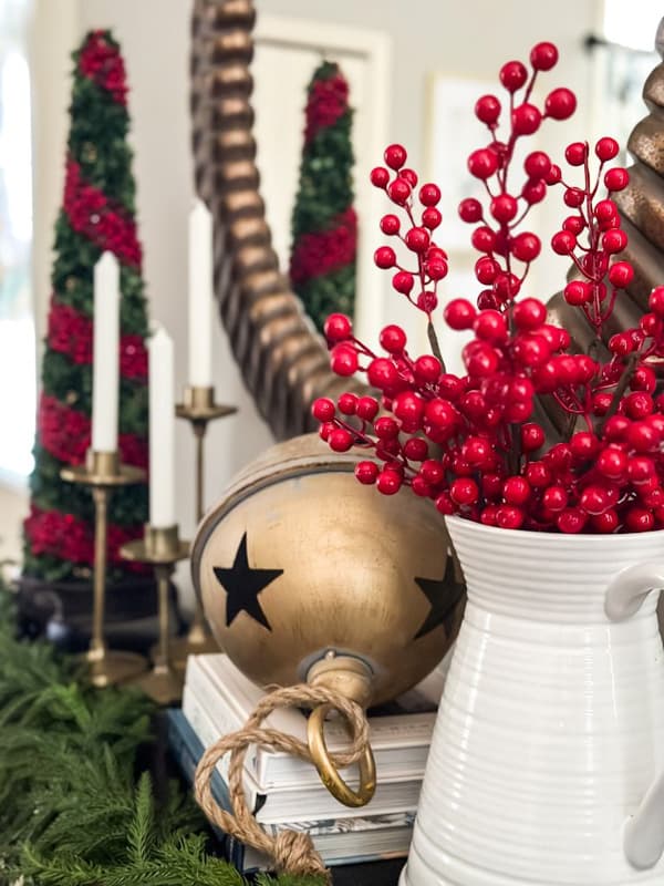 Entryway Christmas decorations with red berries and gold bells