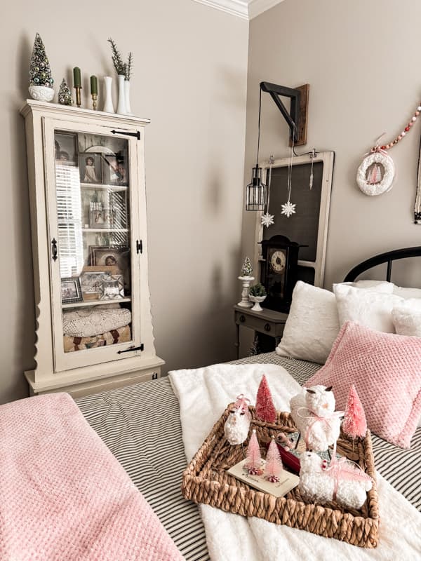 DIY Repurposed gun cabinet in guest bedroom with DIY upcycled tin can Christmas sheep.