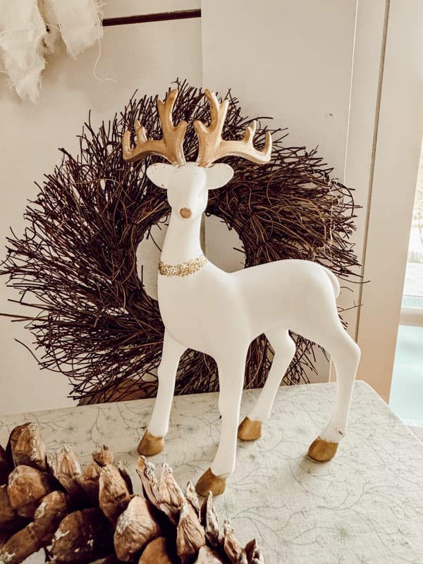 Glamorous Christmas Reindeer with gold antlers and a glitter necklace.  DIY High-end Reindeer -Budget-friendly Holiday Decor.
