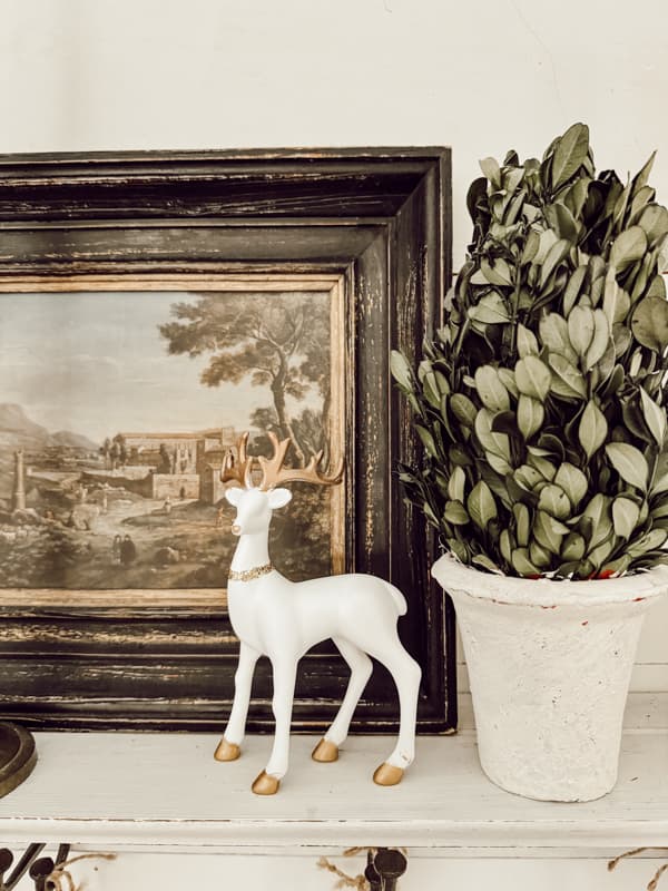 Gold and white reindeer on open shelf for Budget Christmas Decor. DIY High-End Reindeer project.