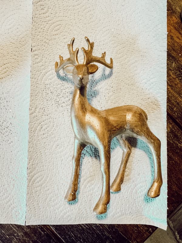 Paint cheap reindeer gold for a DIY high-end reindeer look - Budget-friendly Holiday Decor.